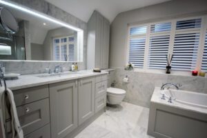 Painted shaker bespoke bathroom furniture with carrara marble surface.