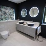 3. A stunning double basin. Glass fronted furniture with a solid surface worktop.