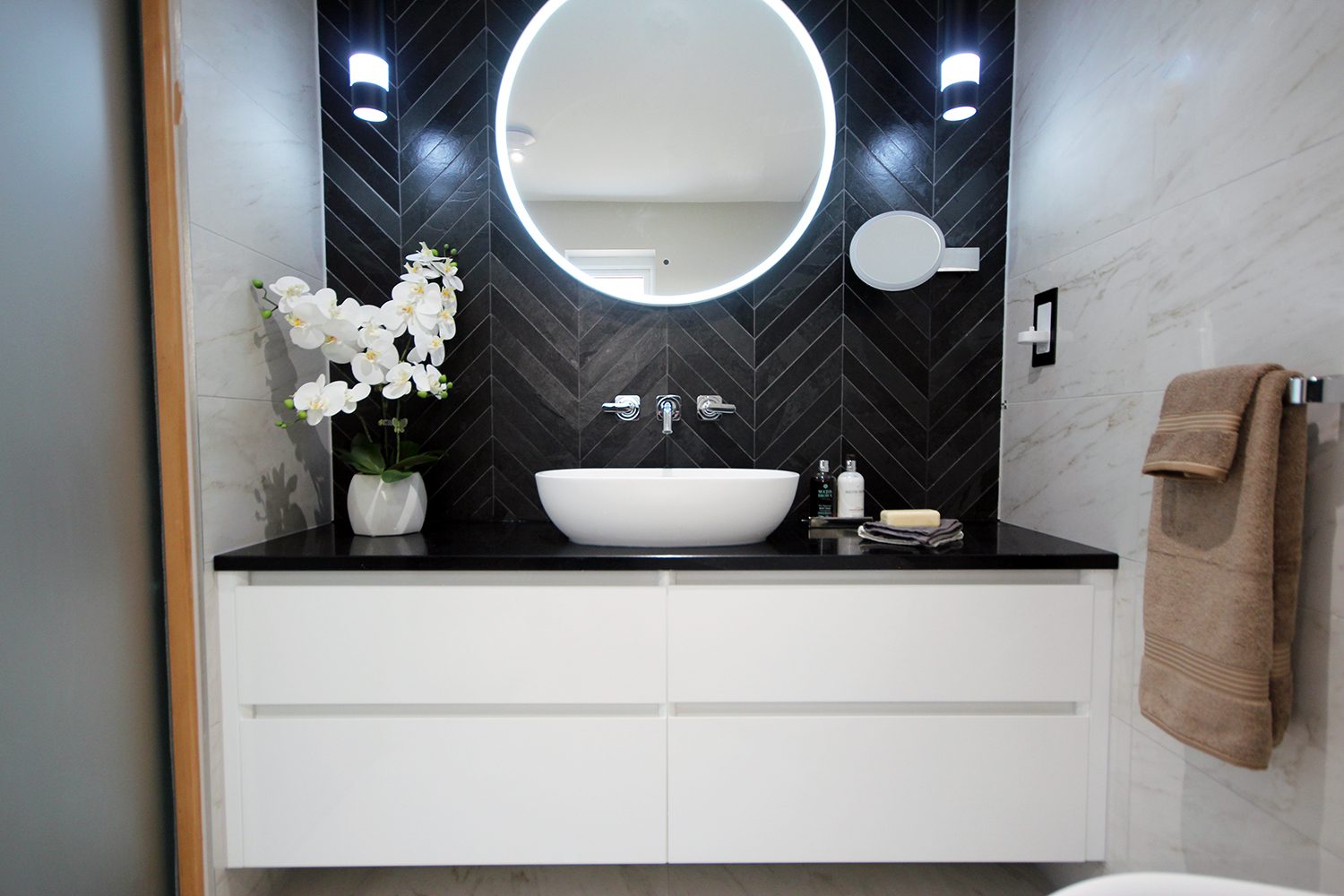 Bespoke wall too wall bathroom vanity with chevron tiles from Ca'Pietra.