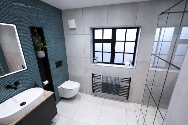 Stylish & Contemporary family bathroom. Striking blue tiles paired with the black brassware creating a contemporary feel.